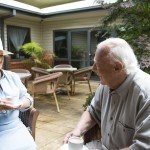 Image of couple sitting in the garden talking at Greenway Gardens